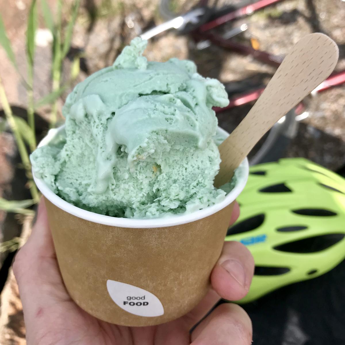 A portion of green ice cream in a cup.