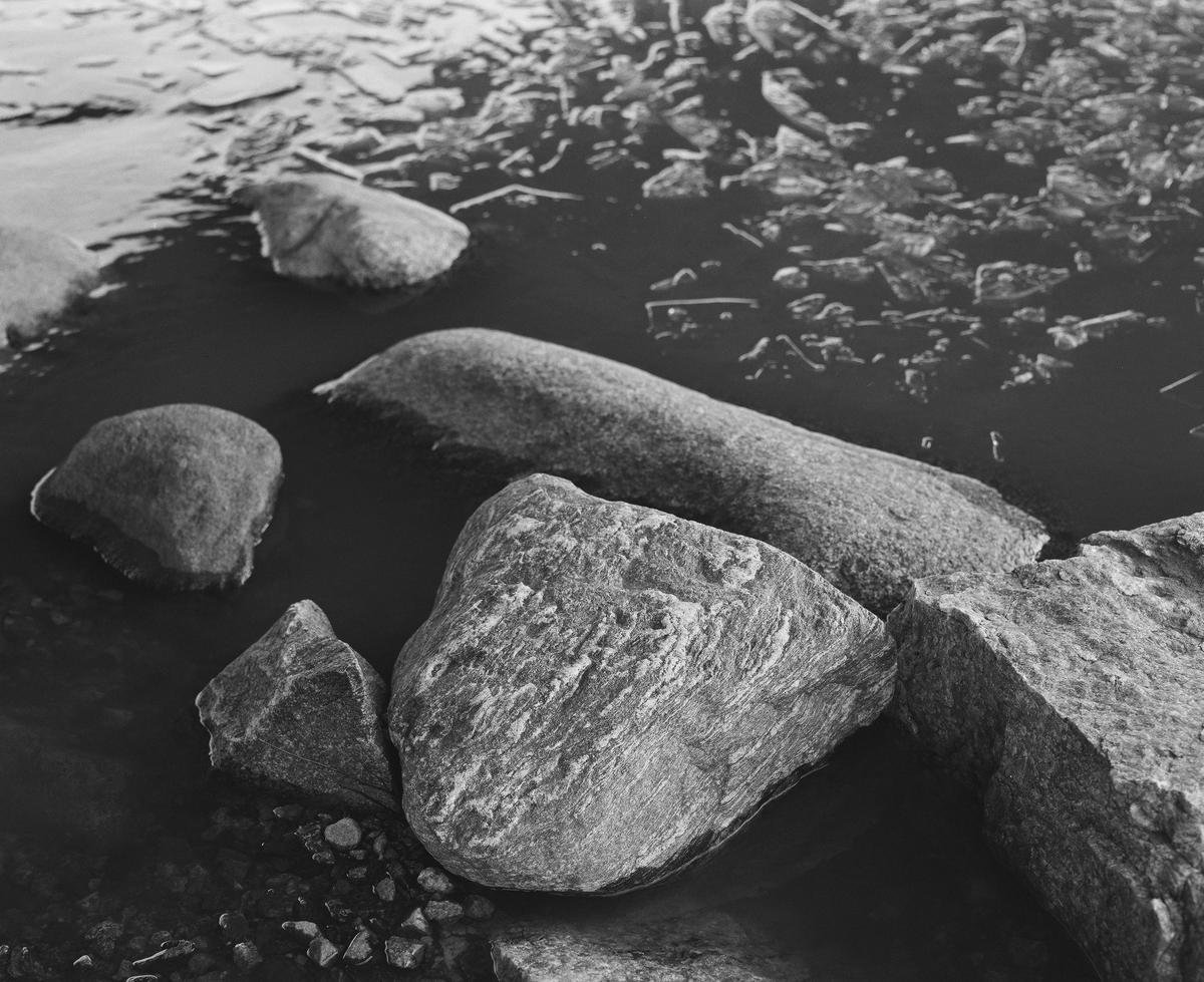 Rocks and thin ice in the shoreline.