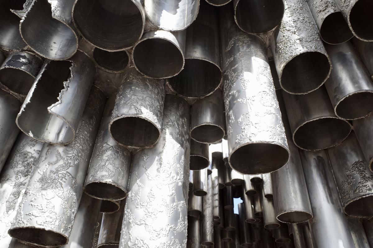 The pipes of Sibelius Monument from below. There's a small patch of sky visible between the pipes.