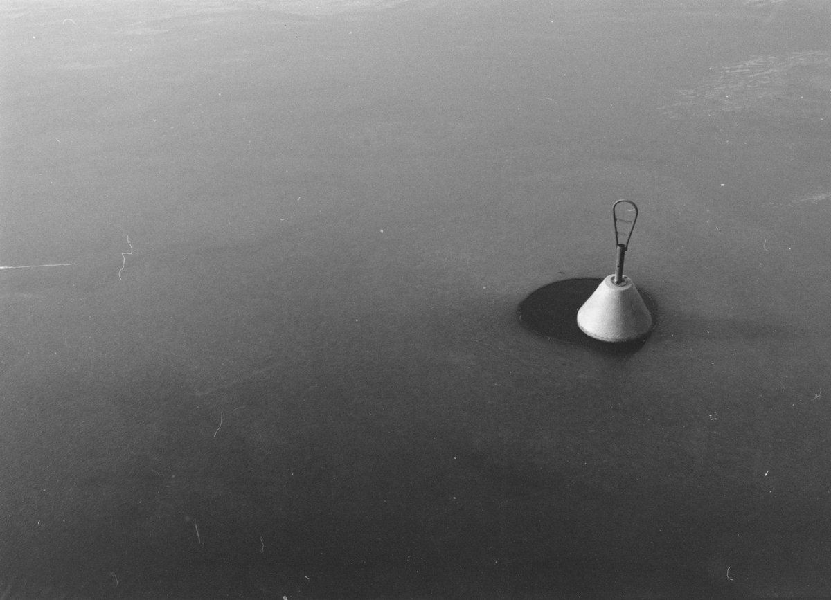 A buoy surrounded by ice.